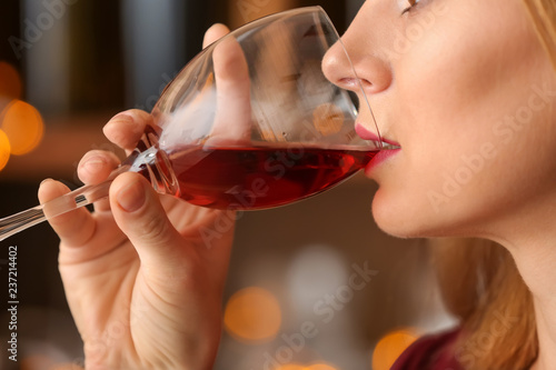 Beautiful woman drinking tasty red wine, closeup