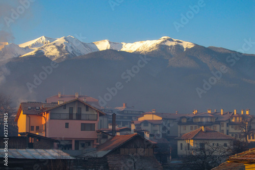 Landscape with house views and beautiful mountains at sunset in Bansko, Bulgaria.