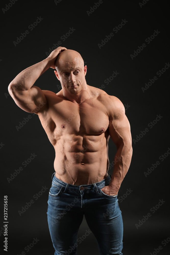 Fototapeta premium Muscular bodybuilder on dark background