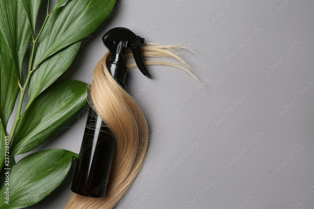 Spray bottle with cosmetic for hair on grey background, top view - obrazy, fototapety, plakaty 