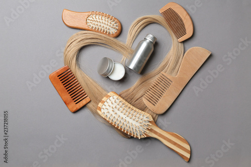Flat lay composition with cosmetics for hair on grey background