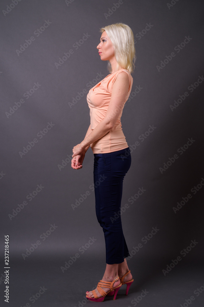 Full length profile view portrait of beautiful woman with blond hair Full length profile view portrait of beautiful woman with blond hair