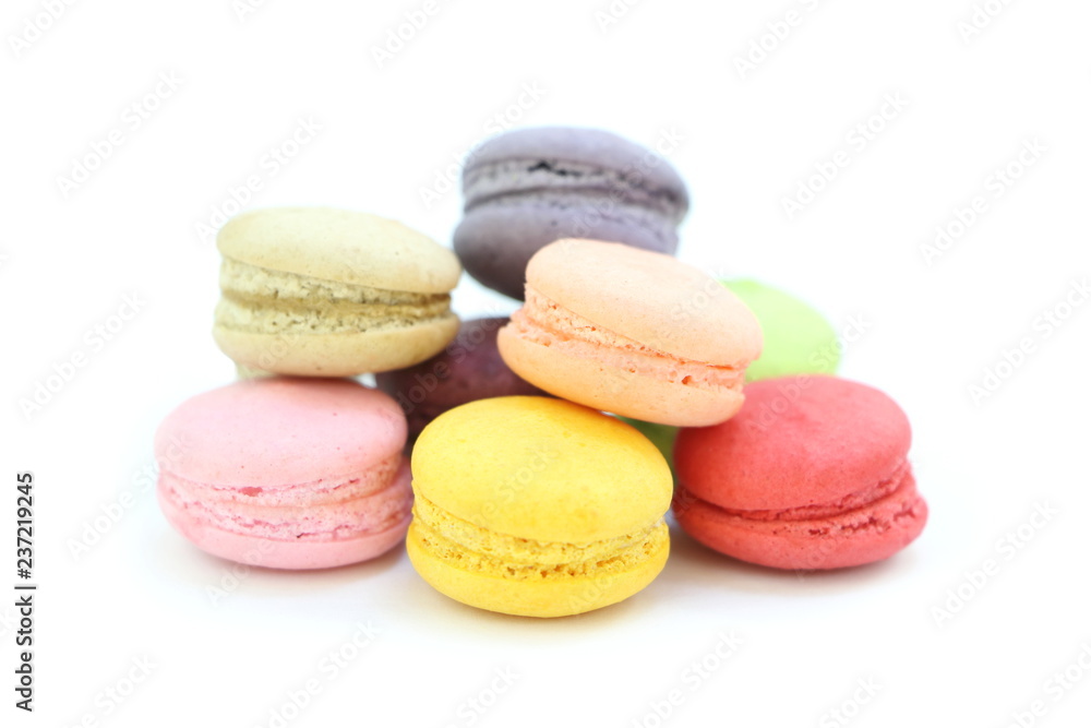 Close up many colorful fresh macarons pile isolated on white background, look delicious Close up many colorful fresh macarons pile isolated on white background, look delicious