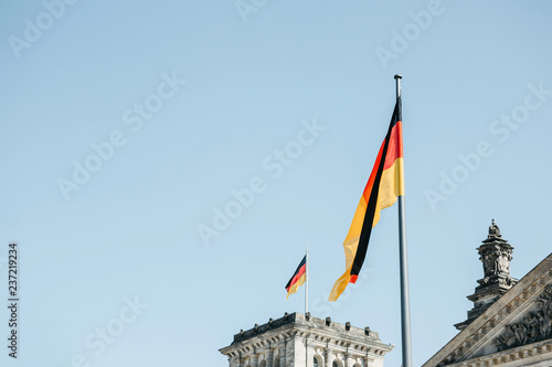 German flag over the Reichstag building in Berlin in Germany.