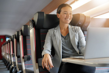 Young businesswoman working in first class on a train