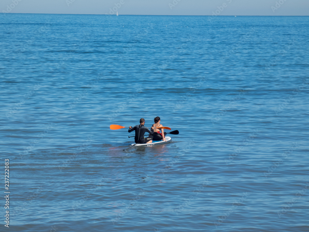 Fototapeta premium Man and woman swims on kayak in the sea . Kayaking concept