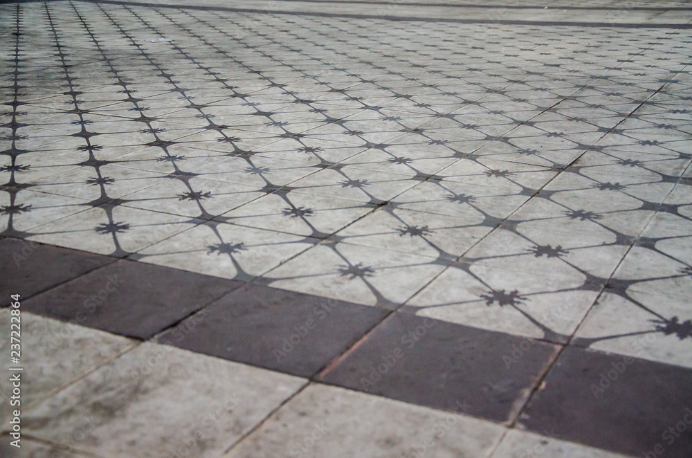 Fototapeta premium Old ceramic floor detail with colors brown and white with perspective