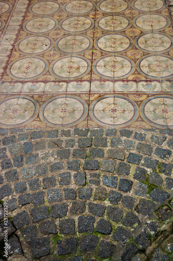 Cobbled entrance mixed with antique traditional faded tiles