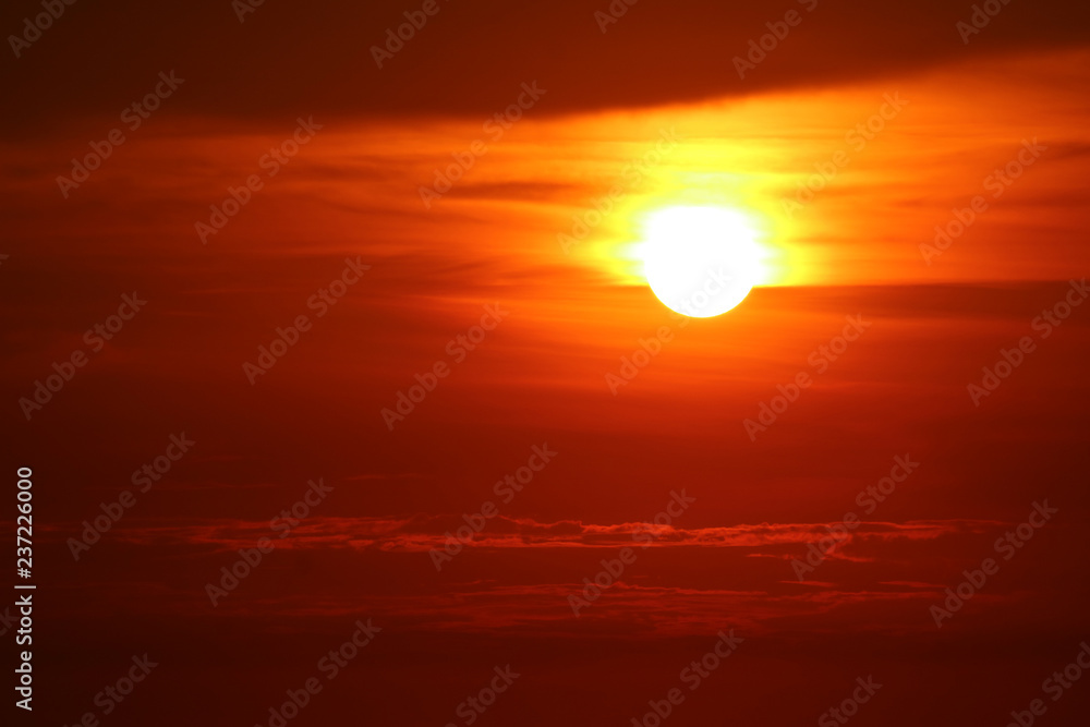 last light of sunset on the red cloud orange sky and ray around sun