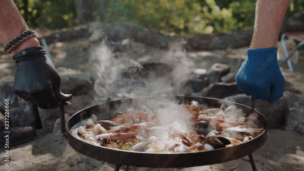 cooked paella with crayfish on a campfire cooked paella with crayfish on a campfire