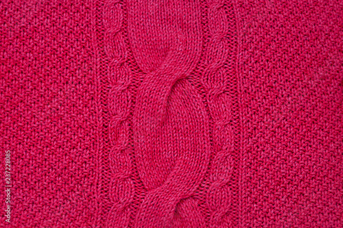 Red Knitted hand made material pattern background. Close up
