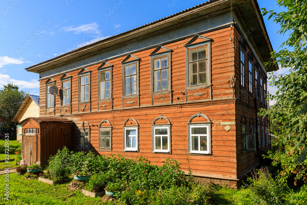 Wooden house with carved polisade in Totma. Russian traditional architecture lies in wooden houses with manually carved decorations, often painted in white.
