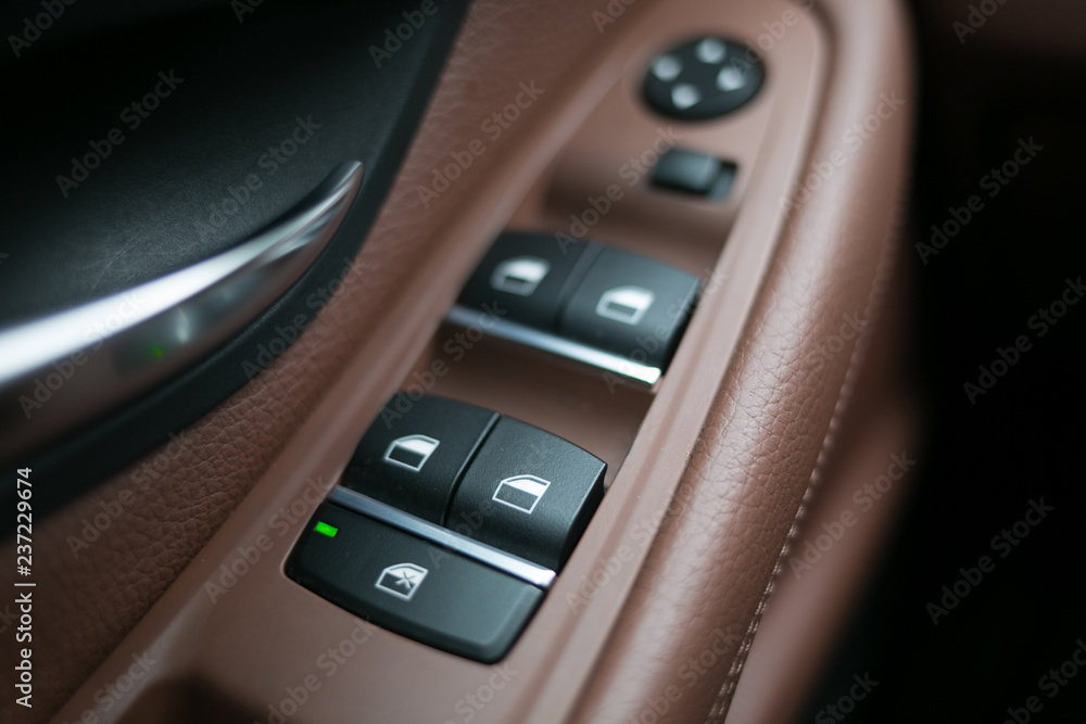 Mirror control knob in a modern car. Auto window button control inside driver place.