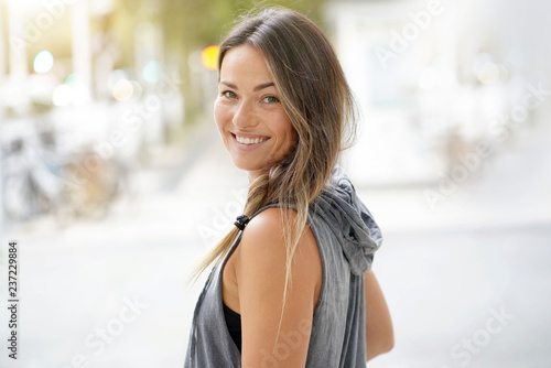  Woman in urbanwear turning around and smiling at the camera