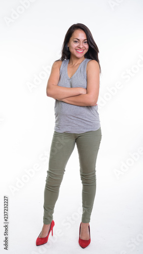 Full body shot of happy beautiful woman smiling while standing w