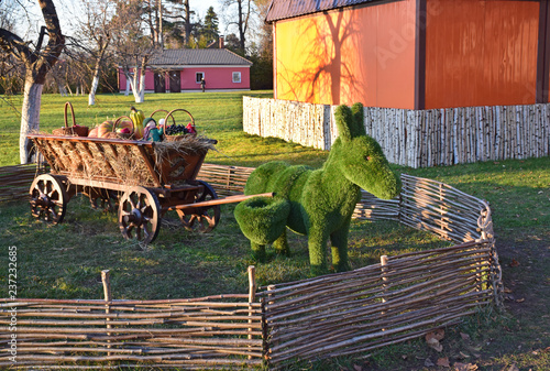 Sculpture of a donkey with a cart in the park next to the Cathedral of Prince Igor of Chernigov. Russia, Moscow, October 2018 photo