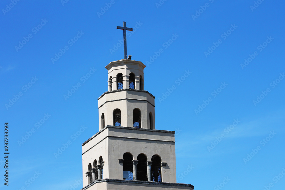 Cross on the top of a church spire, St. Petersburg, Florida. Spire and cross against background of blue sky.