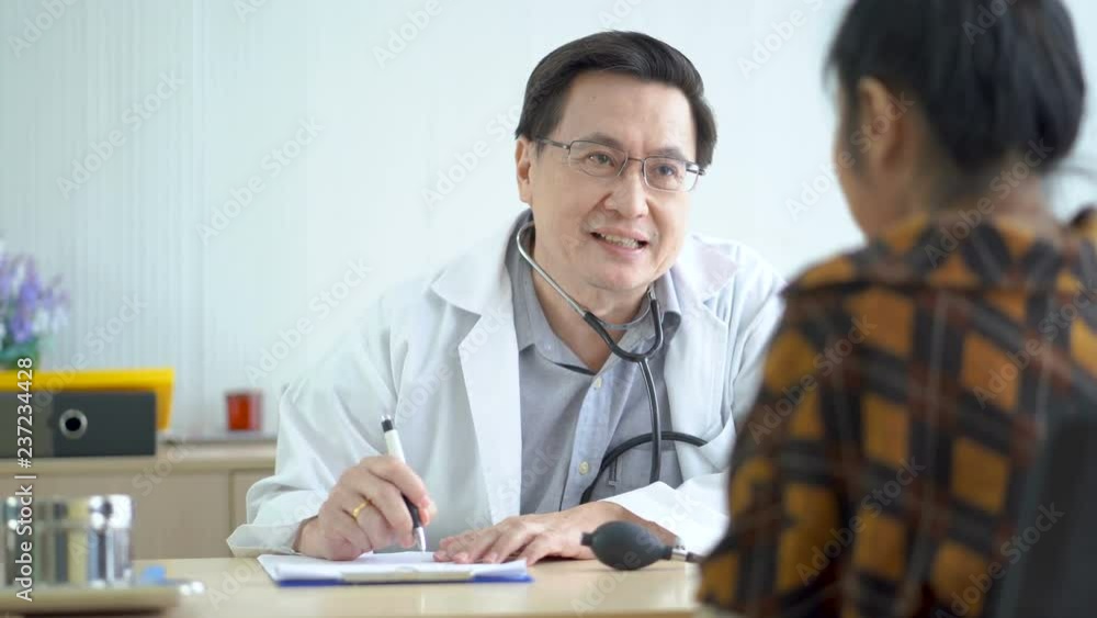 Senior male doctors ask and talk about illness and give advice on how to treat patients in a friendly manner. Senior male doctors ask and talk about illness and give advice on how to treat patients in a friendly manner.