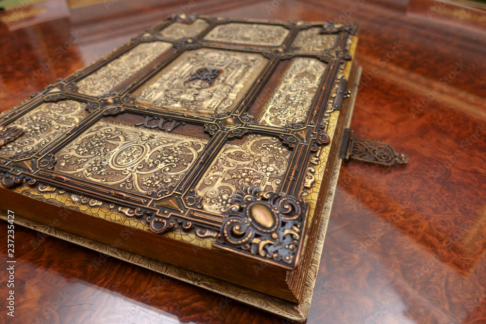 Antique book, with brass clasps on the old table. Medieval period of fantasy  and religious concept. Stock Photo | Adobe Stock