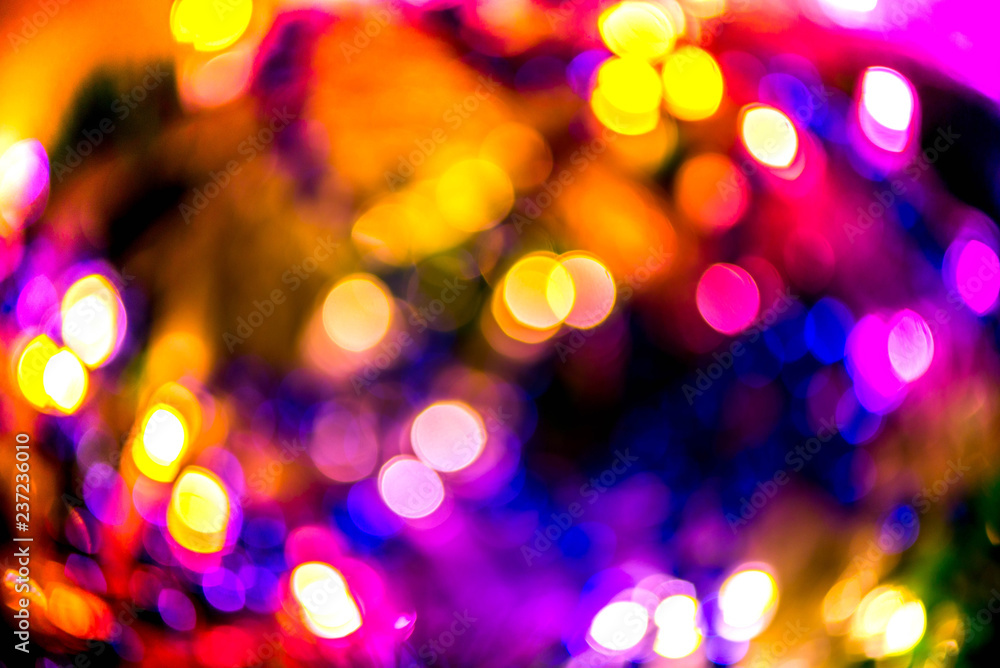 Abstract, colorful, blurry christmas background. Glowing and sparkling lights during night.   