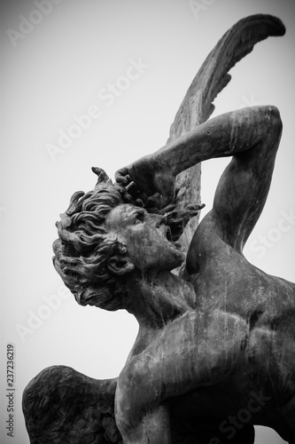 Sculpture  of  Fallen Angel in park El Retiro  Madrid Spain