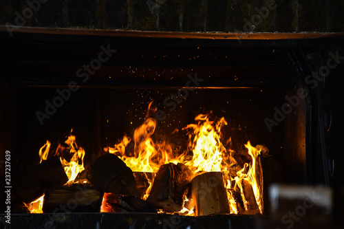 The flames of the fire in the fireplace winter
