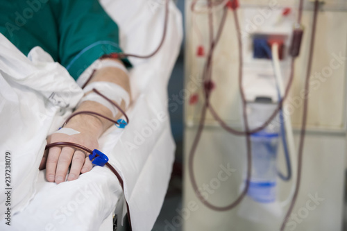 Картината върху платно patient helped during dialysis session in hospital