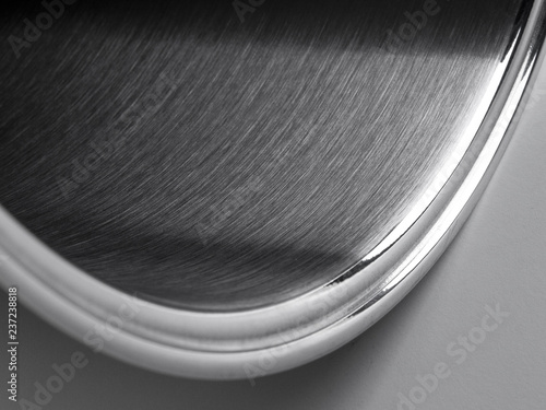 Detalle abastracto en close up de una Cacerola inox vista parcialmeter sobre un fondo blanco 1 photo