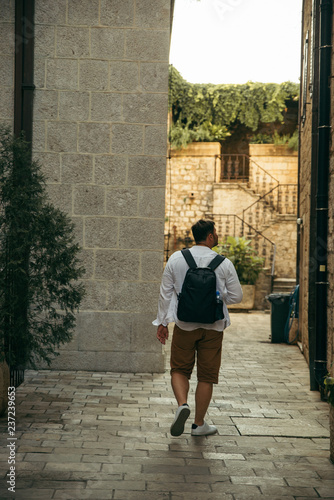 man walking by tight kotor streets © phpetrunina14