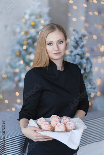 
Woman with cupcakes in her hands.