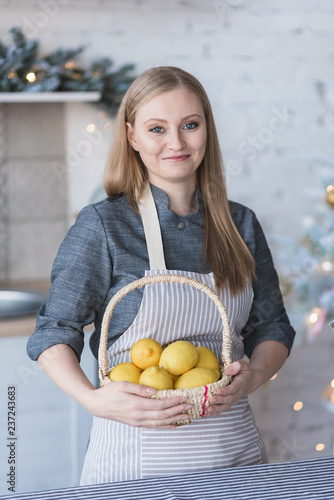 
Woman with lemons in a basket.