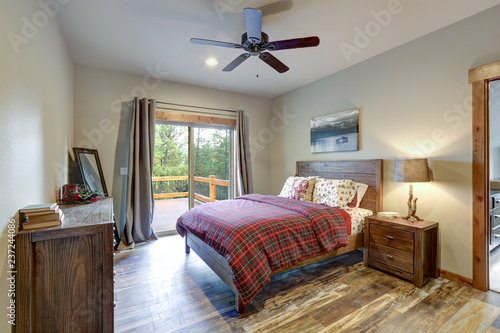 Restful country bedroom with wooden bed and dresser