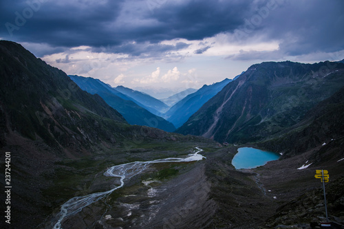 Valley in the Alps  Austria  Europe . Beautiful nature  high mountains  summer day  snowy peaks. Hike in the rocks  traveling with a backpack.