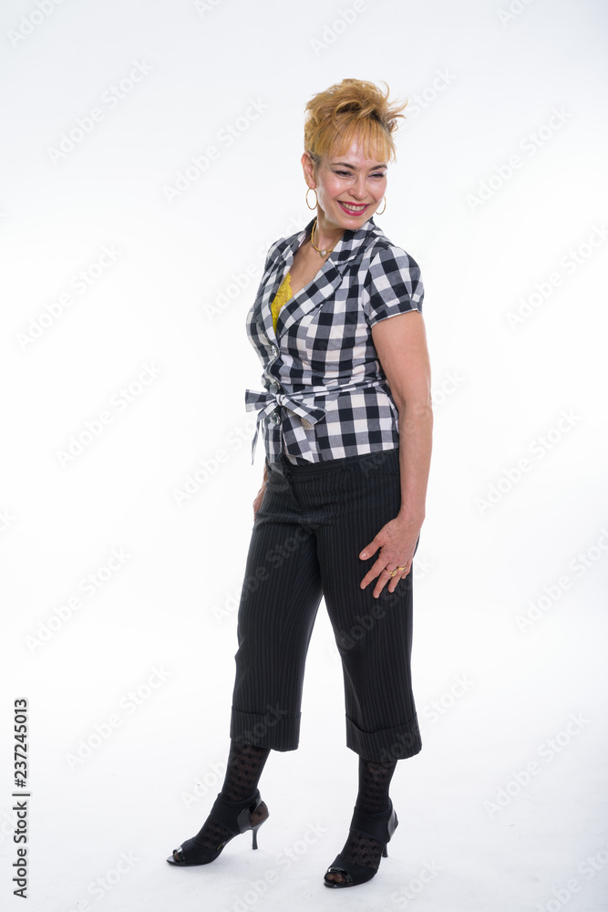Full body shot of happy senior Asian woman smiling and thinking Full body shot of happy senior Asian woman smiling and thinking