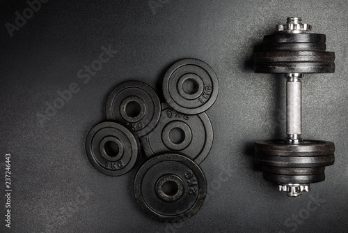 Gym dumbbells with black metal weights 1kg and 2kg on black background with copy sapce, Photograph taken from above photo