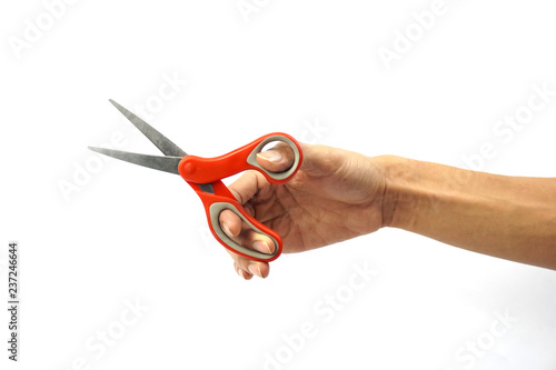 A Cropped of man hand holding red metal scissors against white background.