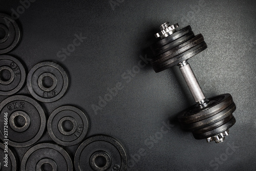 Fotografía Gym dumbbells with black metal weights 1kg and 2kg on black background with copy