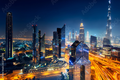 Dubai skyline at night, aerial top view to downtown city center landmarks. Fa...