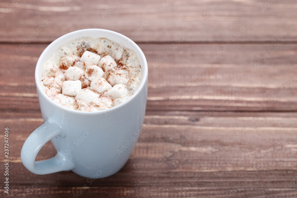 Cappuccino with marshmallows in cup on brown wooden table Cappuccino with marshmallows in cup on brown wooden table
