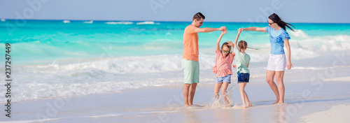 Young family on vacation have fun on the beach