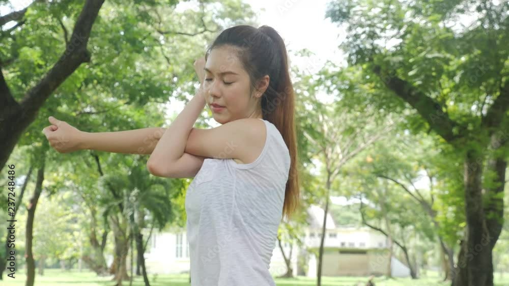 Athletic young asian woman warming up and stretching before workout at sunrise in a Park. Sports healthy lifestyle concepts. Athletic young asian woman warming up and stretching before workout at sunrise in a Park. Sports healthy lifestyle concepts.