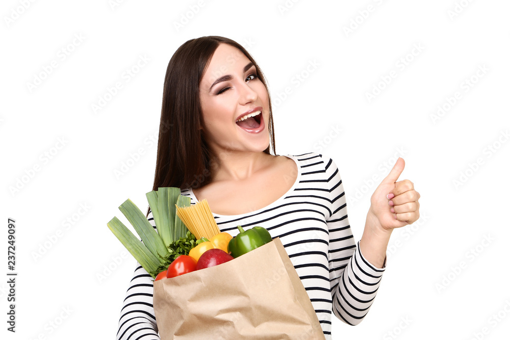 Beautiful woman holding grocery shopping bag on white background