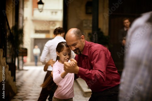 Side view of a man dancing with a girl. photo
