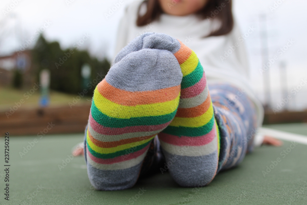 Girl's feet in striped socks Stock Photo