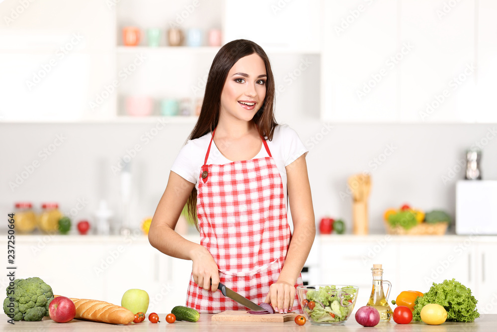 Beautiful woman cooking salad in the kitchen Beautiful woman cooking salad in the kitchen