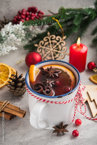 Mulled wine with spices and christmas decoration