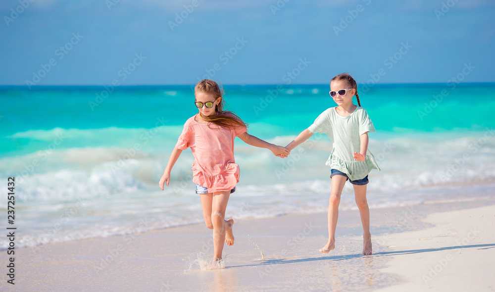 Adorable little girls at beach during summer vacation