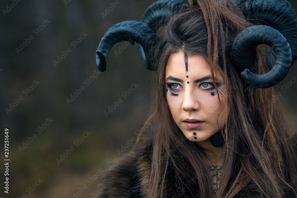 Outdoor portrait of beautiful scandinavian viking woman warrior with blue eyes wearing ram horns. Female with specific makeup fur Stock Photo | Adobe Stock