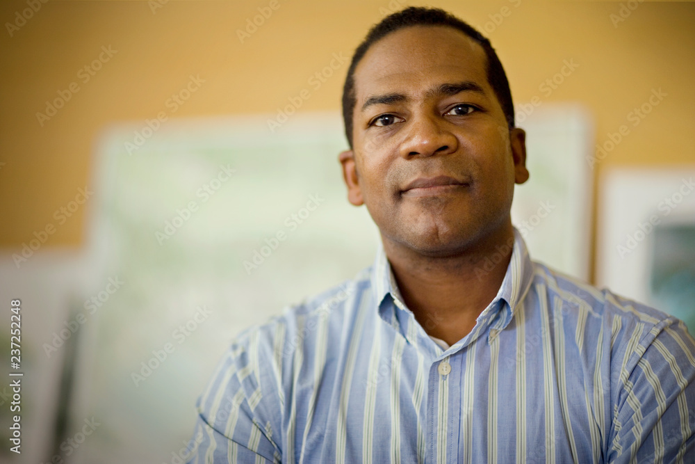 Portrait of a mid-adult businessman sitting in an office. Portrait of a mid-adult businessman sitting in an office.