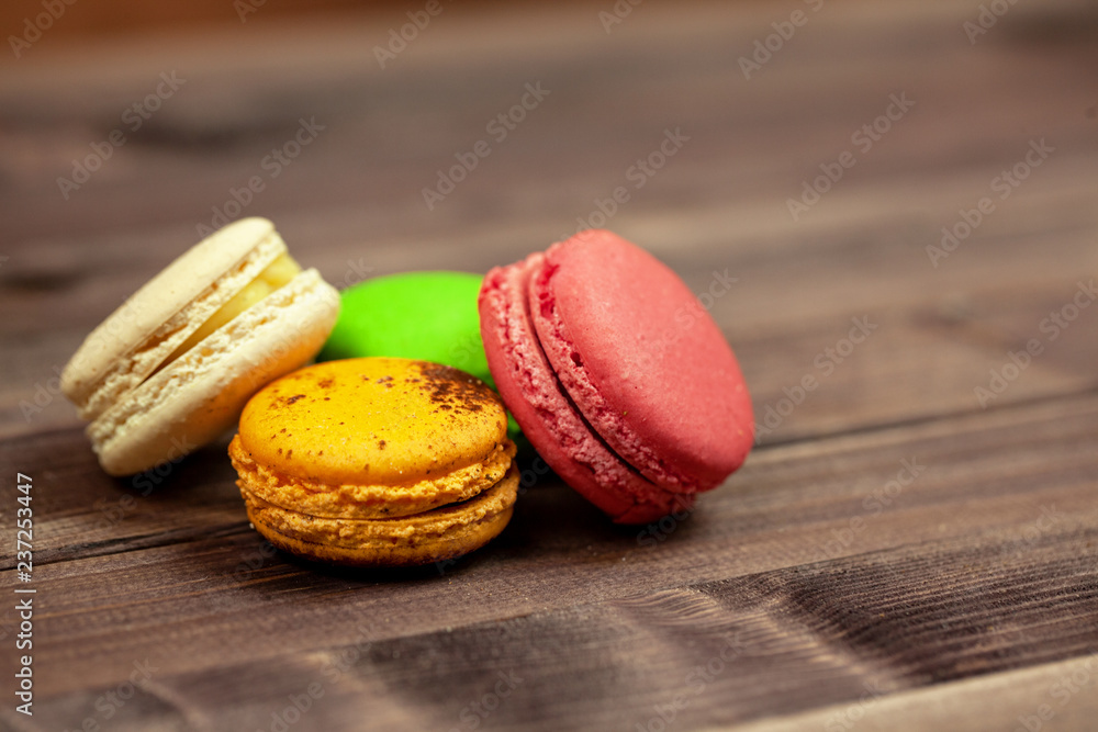 Colorful macaroons on wooden background. French dessert macaroons Colorful macaroons on wooden background. French dessert macaroons